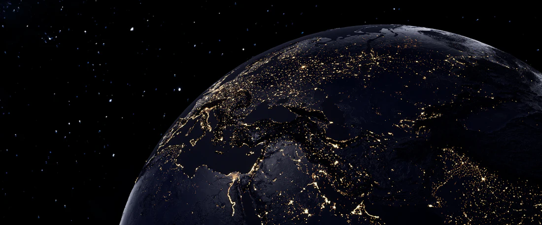 Earth at night seen from space, city lights forming a connected network